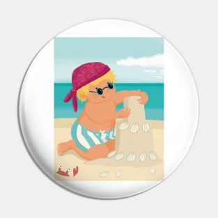 Cute little boy is on vacation building a sand castle on the beach Pin