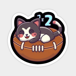 Cat napping on a American football Magnet