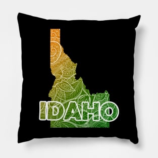 Colorful mandala art map of Idaho with text in green and orange Pillow