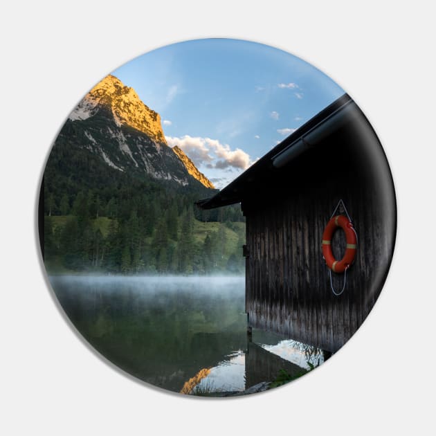 Boathouse with lifesaver Portrait. Amazing shot of a wooden house in the Ferchensee lake in Bavaria, Germany, in front of a mountain belonging to the Alps. Scenic foggy morning scenery at sunrise. Pin by EviRadauscher