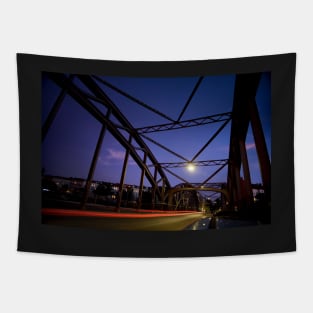 Perspective of an iron bridge with car light trails at twilight in Berlin, Germany Tapestry