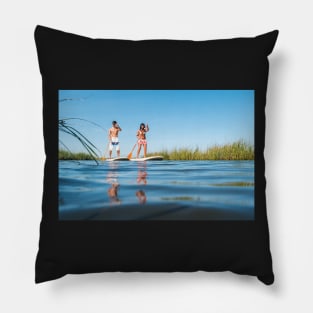 Man and woman stand up paddleboarding Pillow