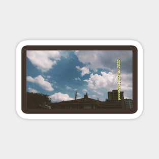 Blue cloudy sky and buildings Magnet