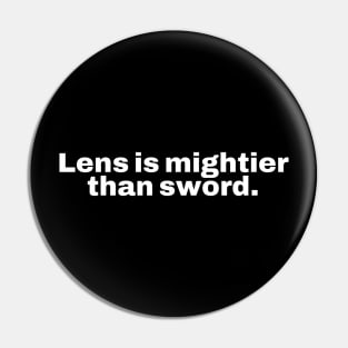 Lens is mightier than sword. Pin