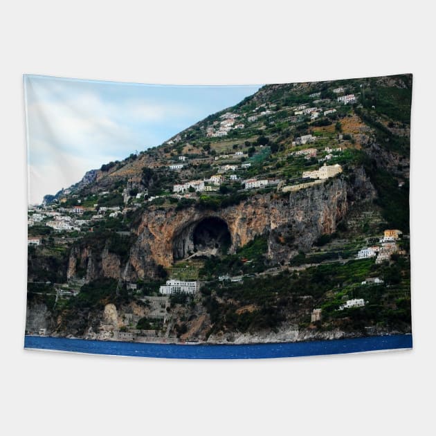 Panorama in Amalfi coast with a mountain scattered with buildings and a huge cavern in the middle Tapestry by KristinaDrozd