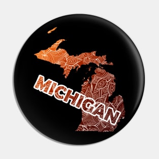 Colorful mandala art map of Michigan with text in brown and orange Pin