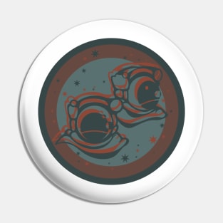 Two astronauts in muted teal and orange Pin