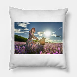 Young woman riding her bicycle in a lavender field Pillow