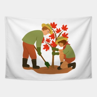 Young couple planting red maple tree. Outdoors gardening concept. Tapestry