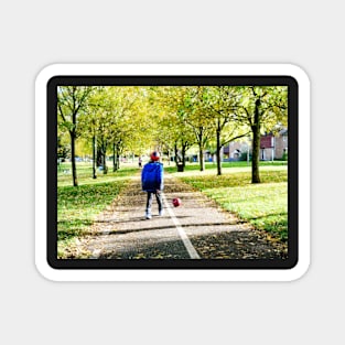 Boy playing football in autumn Magnet