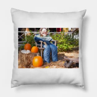 Halloween Mannequin in with ugly mask chair outside beside three large orange pumpkins Pillow