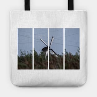 Wonderful landscapes in the Netherlands. Historic dutch windmills in Kinderdijk in a cloudy autumn day. Unesco site. Natural view from distance. Tote