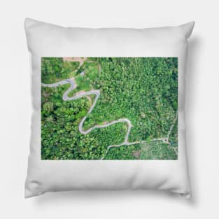 Aerial view of curvy mountain road through a jungle Pillow