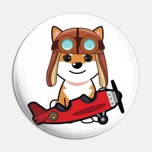 Cute orange dog is in a vintage airplane Pin