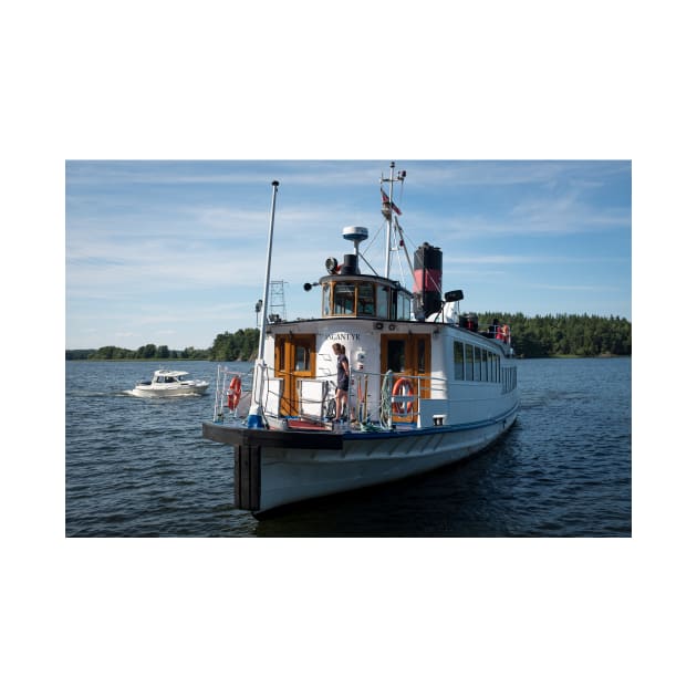 An old steamboat arrives at a pier in the Swedish archipelago by connyM-Sweden