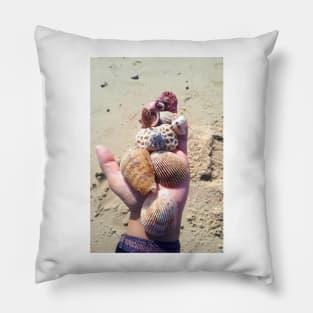 Seashells on a hand at the beach Pillow