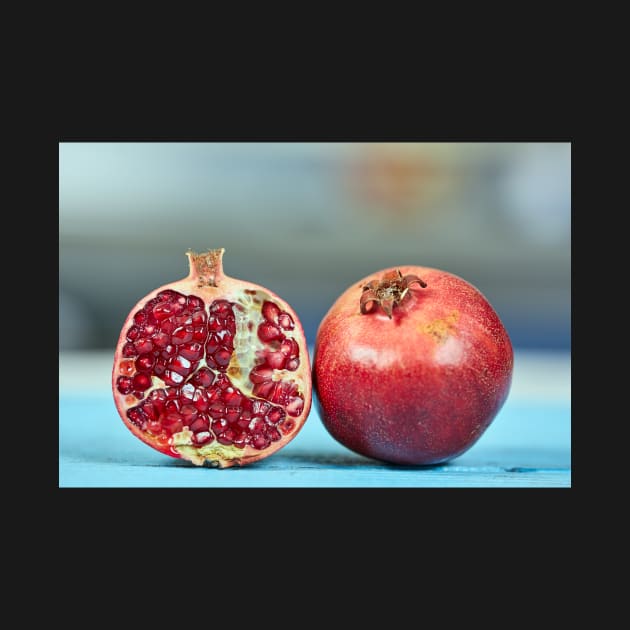 Pomegranate sliced and whole by naturalis