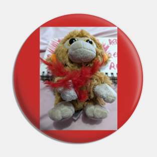 Red boa on toy monkey Pin