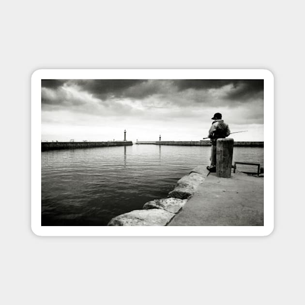 A boy fishing in the harbour at Whitby - Yorkshire, UK Magnet by richflintphoto