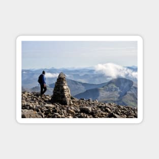 Climber passes a cairn on the summit of Ben Nevis Magnet