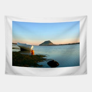 Classic style wooden clinker dinghy on beach. Tapestry