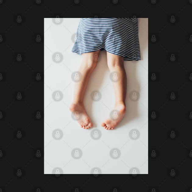 Legs of Small Girl Lying on White Tabletop by visualspectrum