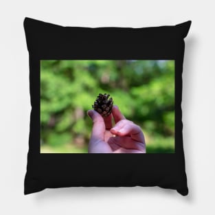 Hand holding pine cone Pillow