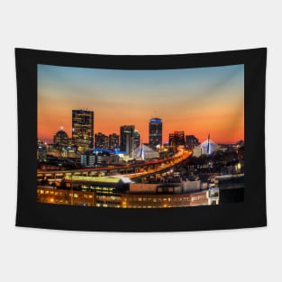 The Boston Skyline lit up blue at Sunset Tapestry