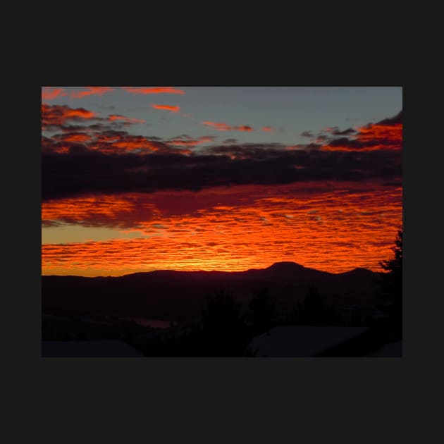 Burnt orange sunset reflecting off the clouds by Steves-Pics