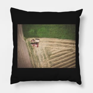 Aerial view of combine-harvester and tractor working in the field Pillow