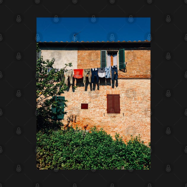 Laundry Drying on Washing Line Against Old Brick Building in Tuscany Italy by visualspectrum