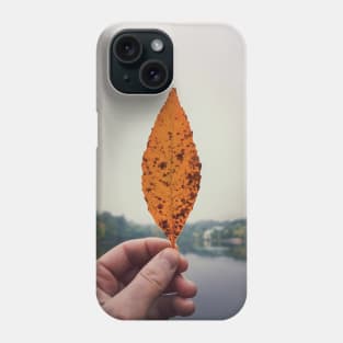 hand holding yellow leaf Phone Case