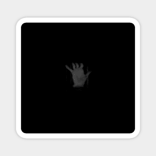 Distorted hand of a man in the dark. Magnet