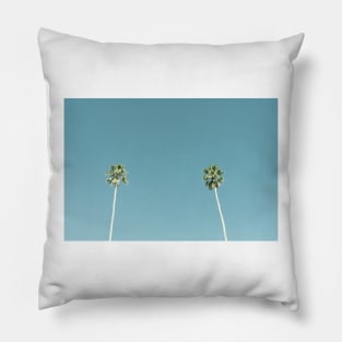 Tall fan palm trees against blue sky Pillow