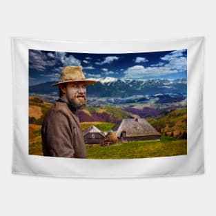 Bearded farmer by his house in the mountain Tapestry