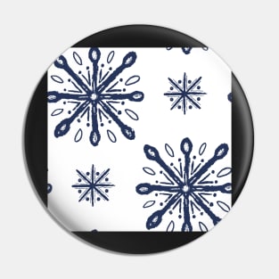 Pattern of blue snow crystals on white Pin