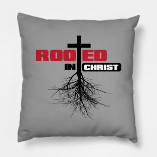 Rooted in Christ with a cross and black text Pillow