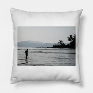 Boy walking through water in low tide Pillow