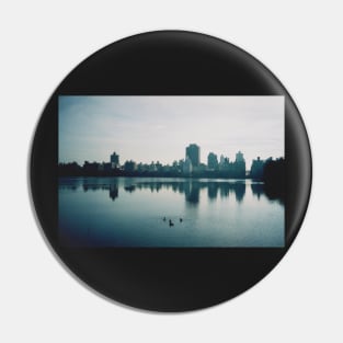 Film photo of Central Park, New York City, with its lake and surrounded buildings Pin