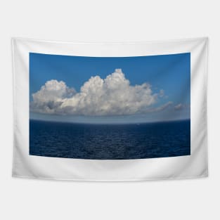 White cumulus clouds in sky over blue Baltic sea Tapestry