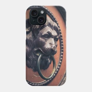 A decorative door knocker shaped like a lion's head Phone Case