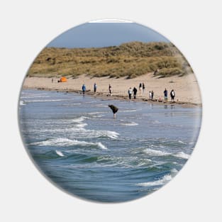 people on the beach at Bamburgh - Northumberland, UK Pin