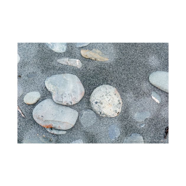 Stone scattered in sand on beach by brians101