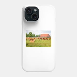 A herd of brown simmental cows grazing on a green pasture Phone Case