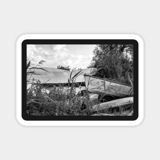 Old canoes and kayaks on the river bank in Thurne, Norfolk Magnet