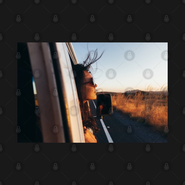 Road Tripping - Beautiful Woman Sticking Head Outside Car Window While Driving by visualspectrum