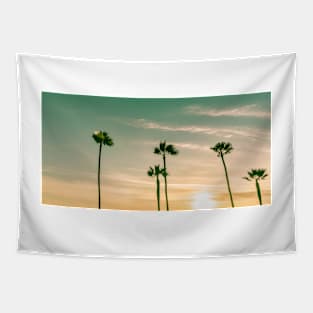 Retro effect image sun setting on horizon through tropical palms Tapestry