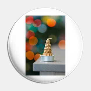 Christmas tree shaped candle on wooden cupboard against christmas lights Pin