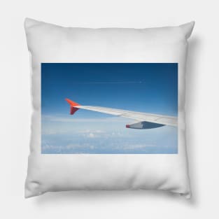 View of an aircraft wingtip with another aircraft visible flying in the distance. Pillow