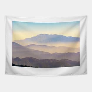 Mountain layers rising to distant peak through hazy light and different color bands. Tapestry